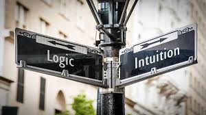 Intuición or logic with white writing on black board in each direction